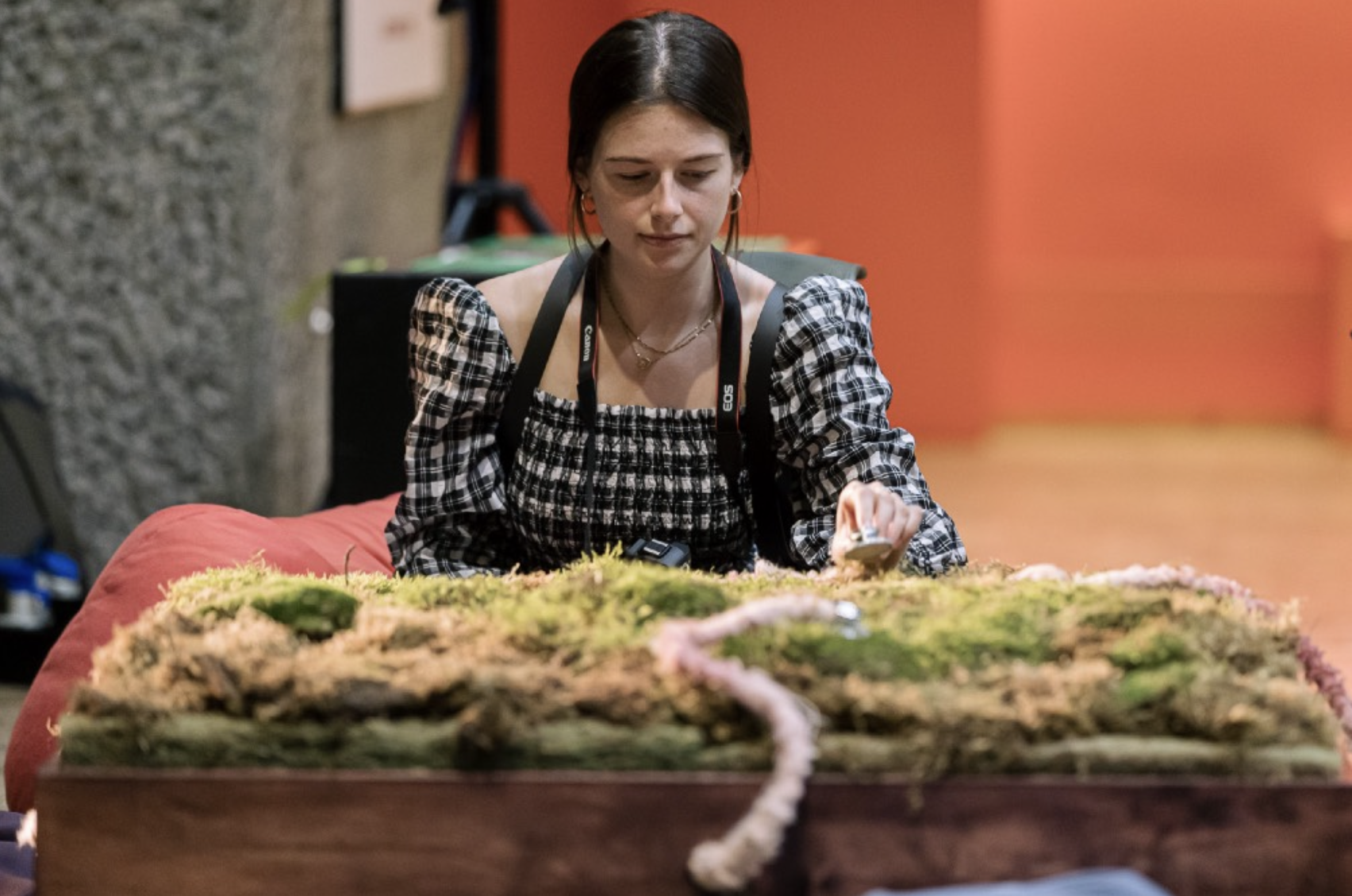 a person looking at a table covered in moss
