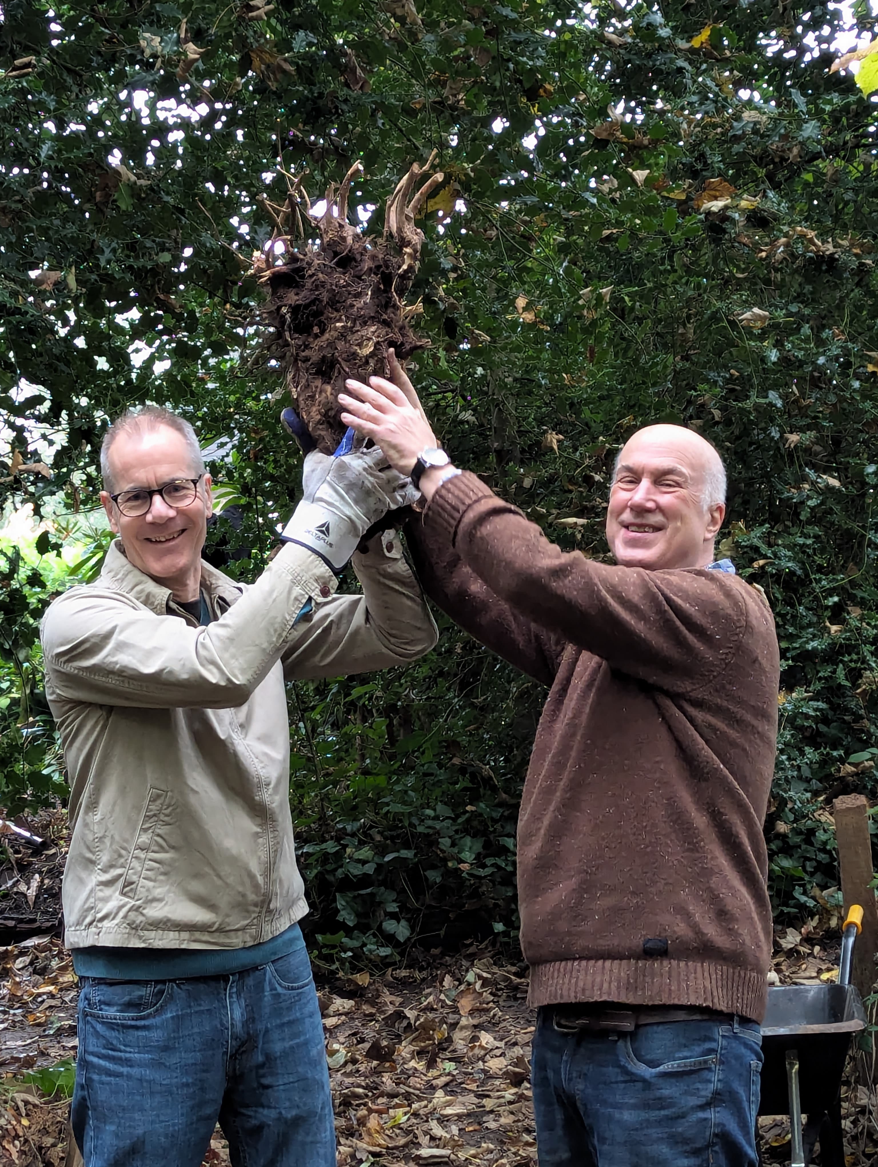 Two men standing in a forest