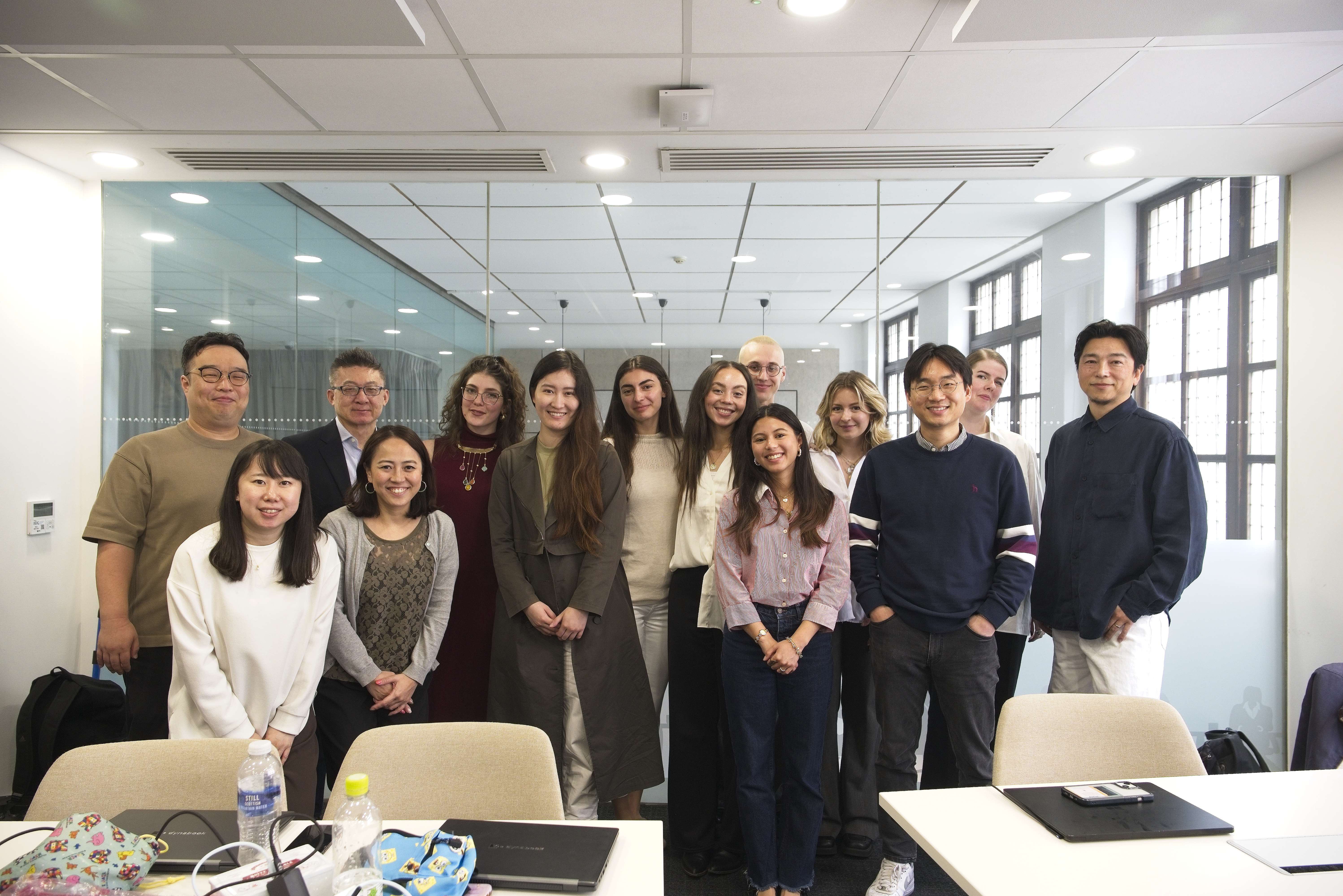 a group of smiling students standing in a classroom