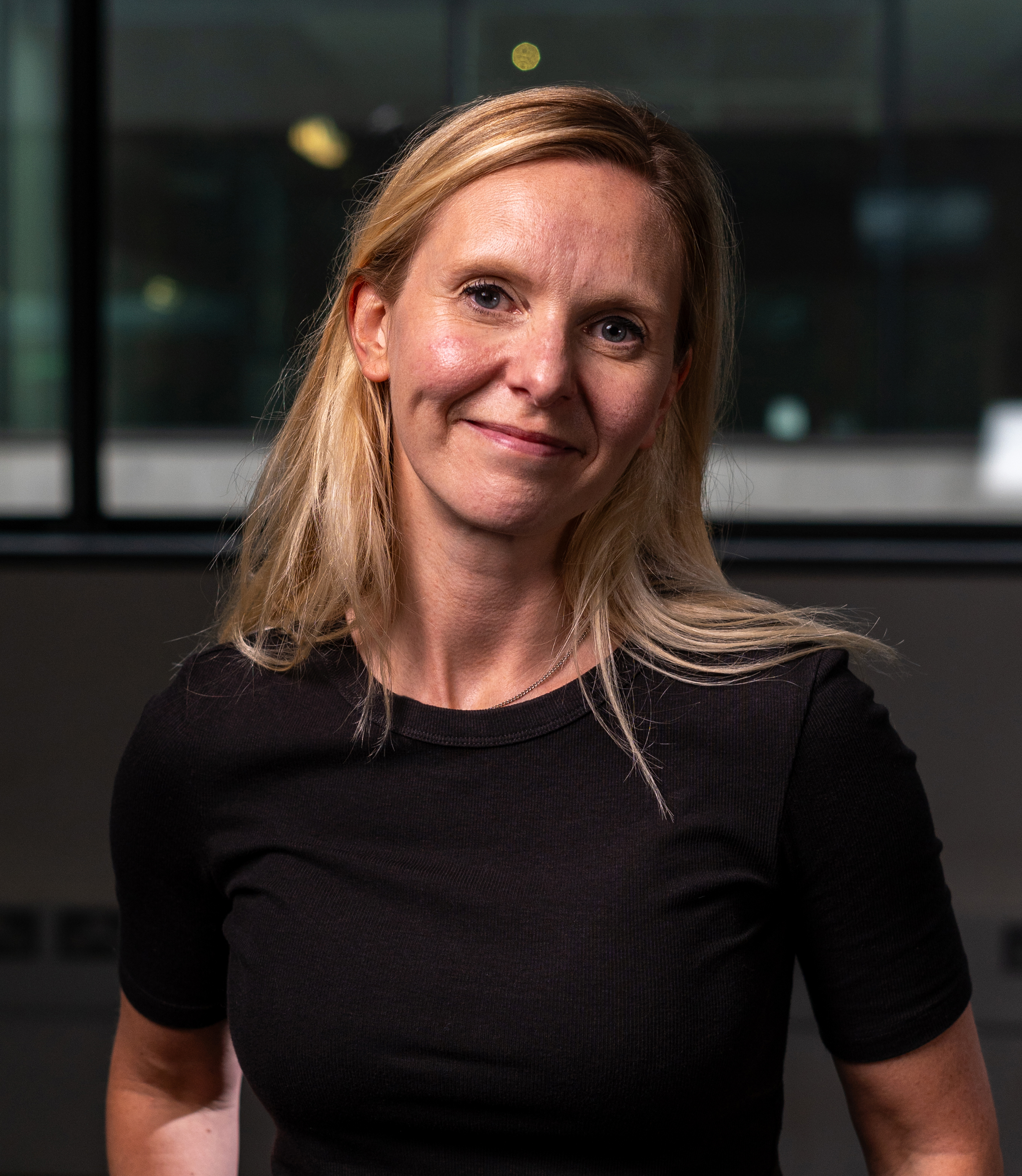Creative Leadership course leader Sophie headshot smiling in black top and blond hair face on to camera