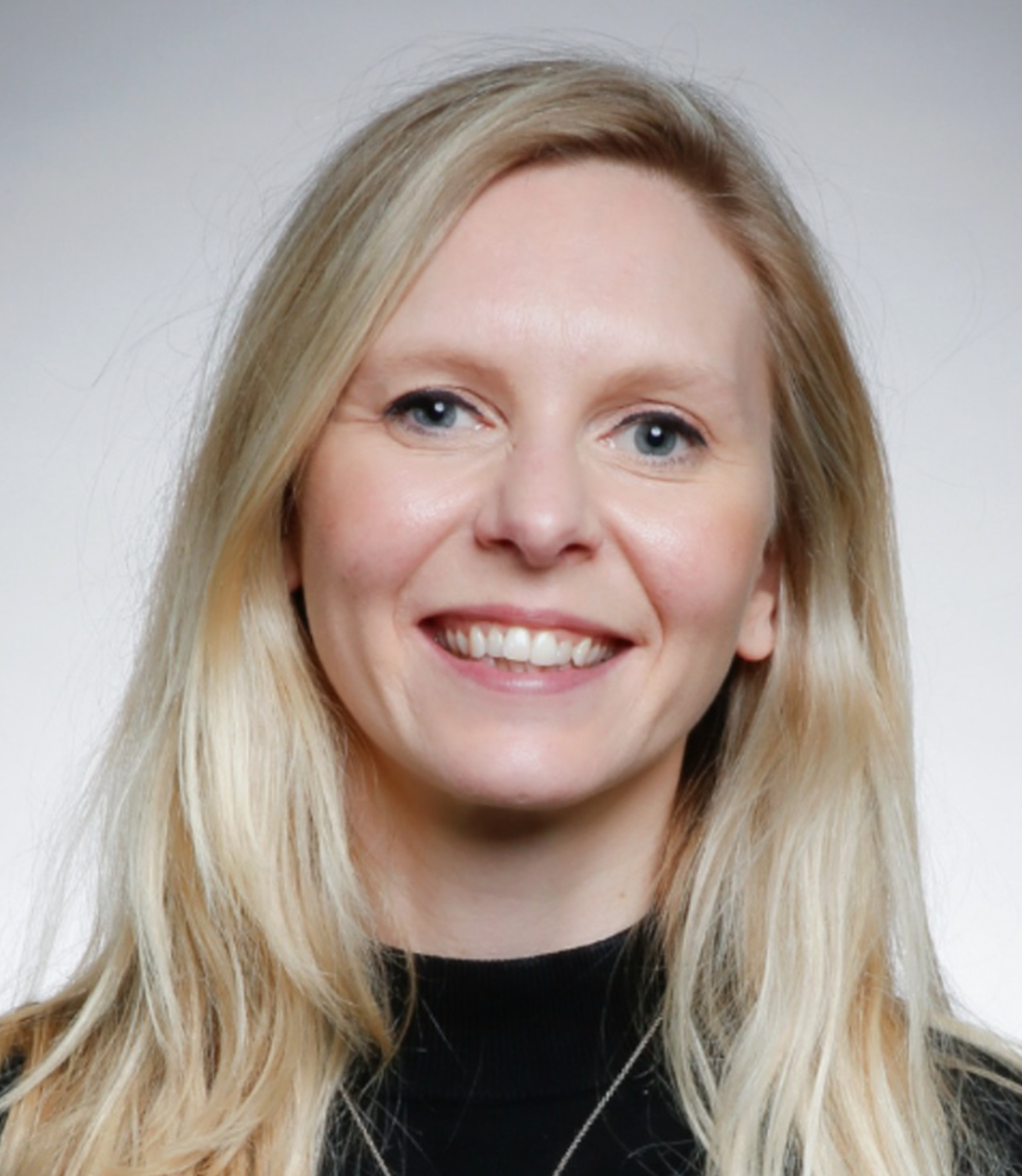 Creative Leadership course leader Sophie headshot smiling in black top and blond hair face on to camera