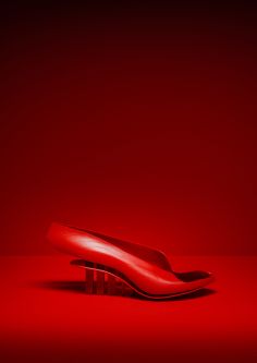 Red shoe against a red background