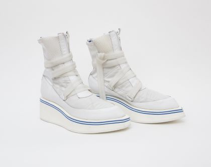 White boots against white background