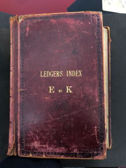 very old business ledger outside red leather