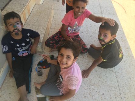 Four children from jordan playing with arts and crafts