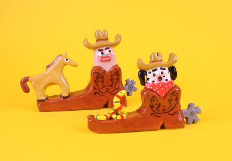 Two ceramic characters dressed as cowboys