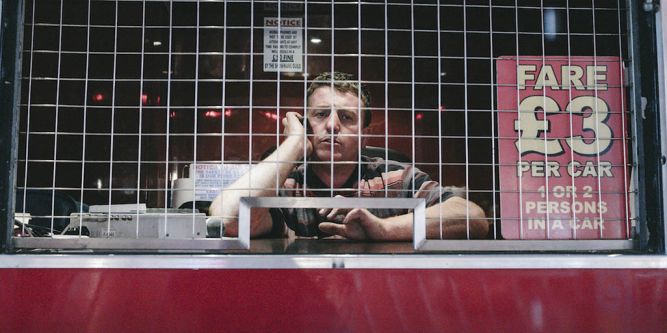 man at fairground desk