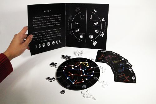 image of game displayed on table. the board is circular and sitting next to the game. the instructions are being held beside it. 
