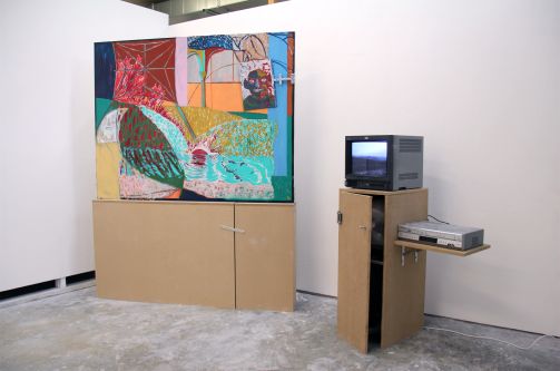 An artwork placed on a plinth next to an old fashioned tv on plinth 