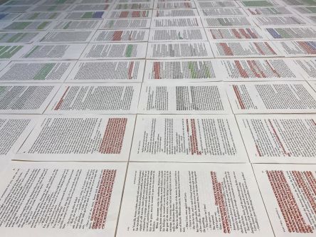 papers with hand highlighted text
