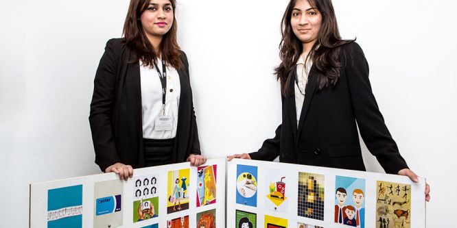 Two ladies pose with examples of ladybird book covers