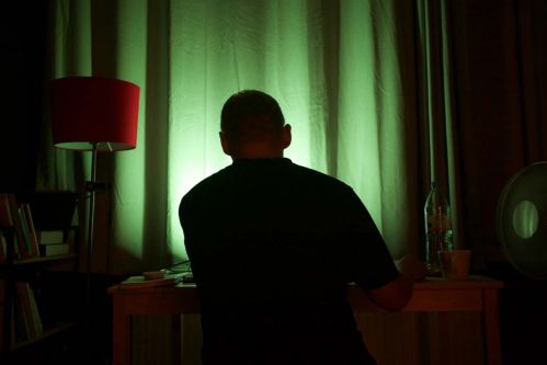 Man at desk with green light