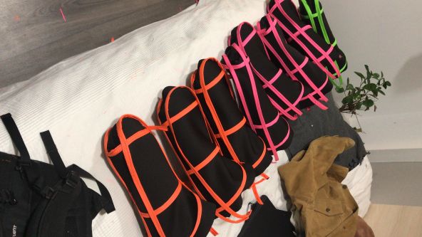 Sections of enlarged thumb structures in black with neon trim lined up before being sewn together