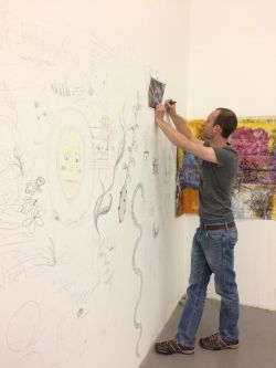 man drawing onto wall