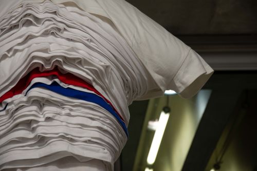 Garment made of many t-shirts layered on top of each other, installed on mannequin