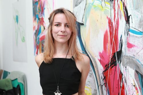 Photo of Daniela Raytchev in front of one of her works