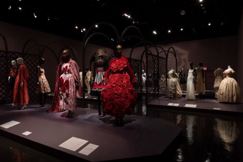 exhibition display of rose themed dresses