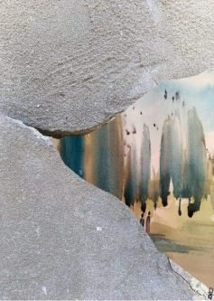 A close-up of a crack in a concrete wall which has had a landscape painted onto it