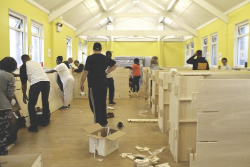People building wooden sleeping pods
