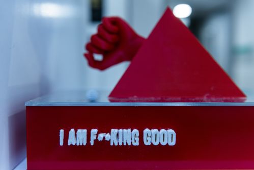 Exhibited work showing a red triangle with the words 