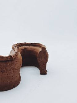Extruded figure of man in brown clay