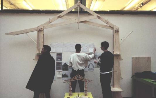 Architecture students set up their work for a final review in the street. 