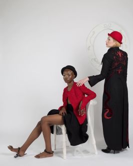 Female model sitting on chair, female model standing up wearing suits