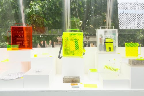 Display of work in the degree show. Neon and red cases.