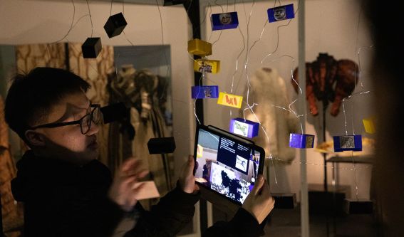 Visitors interact with hanging tablet screens.