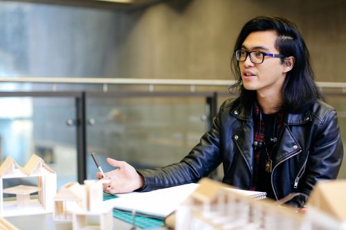 Student with models of a building