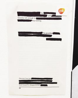 Document with blacked out text. Reads: 