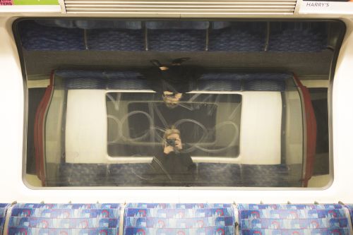portrait of photographer in tube train window