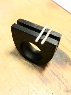 Wooden ring with two straight metal inlay.