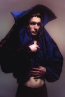 Figure shrouded in blue garment