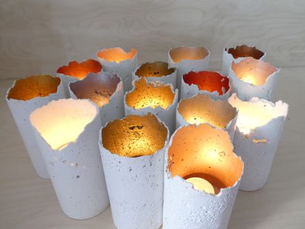15 glowing tea light holders painted with a metallic paint on the inside, created by heimdesign