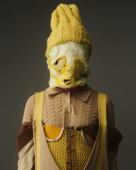 Model wearing positive knitwear covering face
