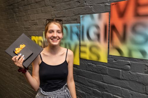 A student prize winner poses with their prize