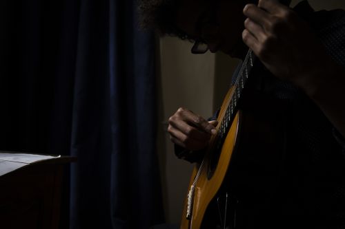 close up of a man playing the guitar