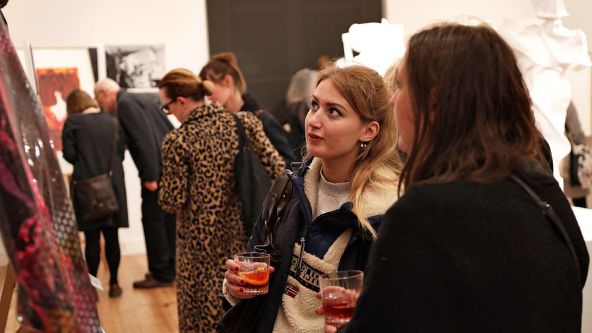 Gallery visitors viewing artwork at the Campari Creates event