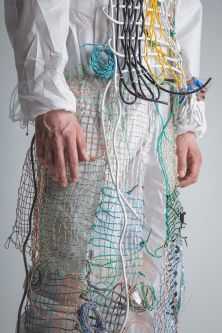 model draped in mesh and wire garment