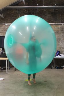 A model wearing a large turquoise baloon 