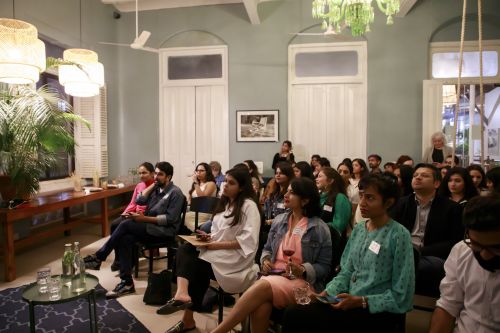 Photo of people sitting down, listening to a talk