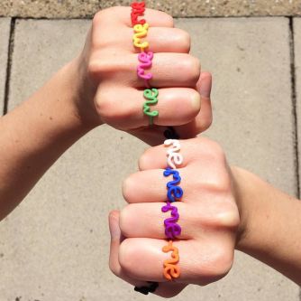 A collection of rings with the words 'me' created by artist and jewellery designer Zoe Sherwood