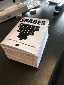 A stack of white books with bold black letters