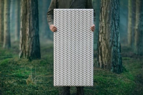 Pale panel held by person in woodland