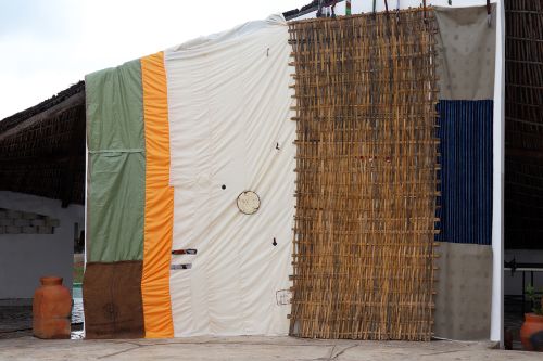 side of a makeshift building covered in fabric and weaved material