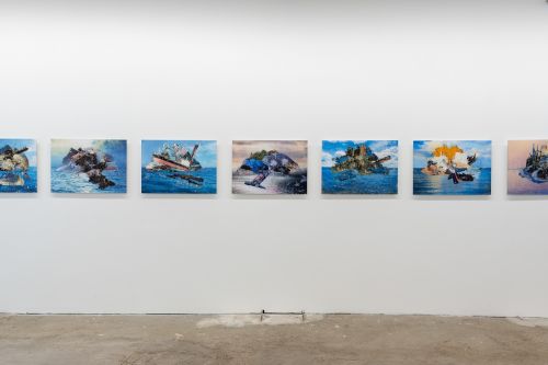 A white wall hung with a series of works all depicting water and waste