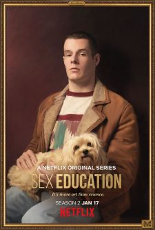A promotional portrait of Adam from the Netflix series, Sex Education, holding a dog.
