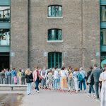 Photograph of people queuing outside the CSM building to get into the degree show