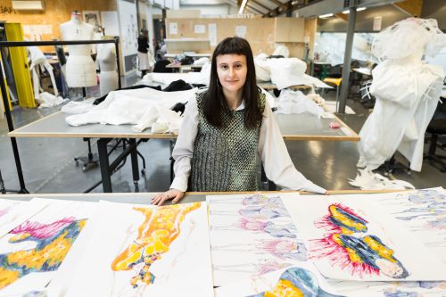 Emily with her colourful fashion illustration portfolio